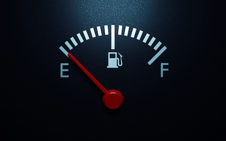 Fuel gauge photo with red arrow at empty