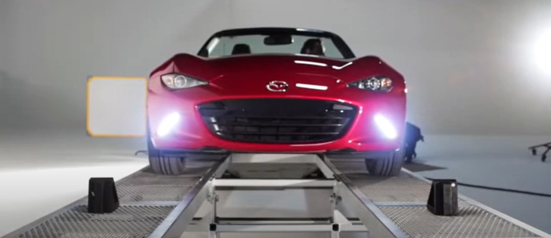Mazda Miata with headlights on, seen from the front