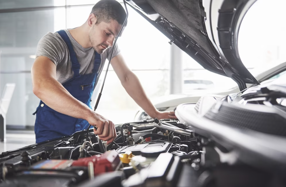 auto mechanic repairing the car - opened car cockpit