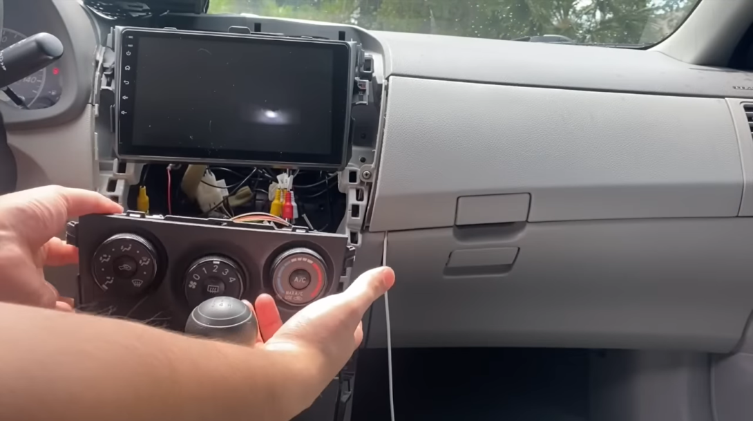 man disassembles the car below the screen