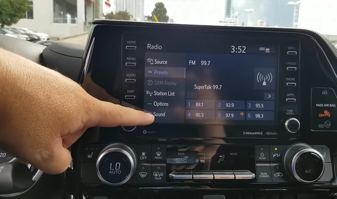 man shows the radio presets on his car screen